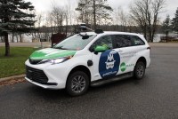 The goMARTI vehicle, a white van painted with green and blue branding, is parked outside.
