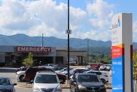 A photo of a hospital parking lot and emergency room entrance.